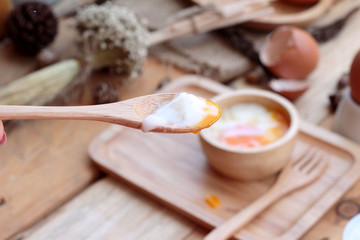 soft-boiled egg and eggs on wood background
