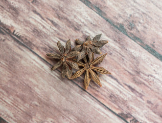 Star anise spices over weathered wooden background