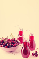 Cherry juice in bottles. The image is tinted.