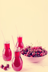Cherry juice in bottles. The image is tinted.