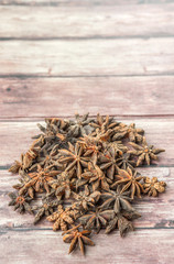 Fototapeta na wymiar Star anise spices over weathered wooden background