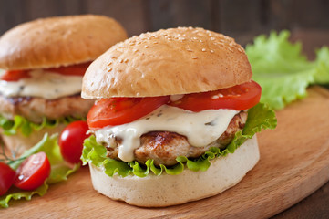 Appetizing hamburger with chicken burger and sauce Tartar