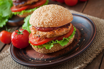 Sandwich with chicken burger, tomatoes and lettuce
