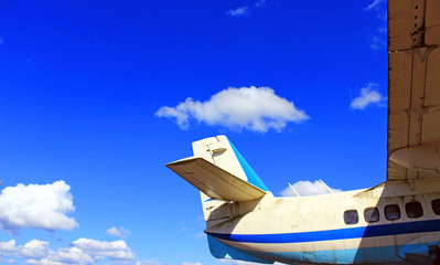 The tail of the aircraft on blue sky