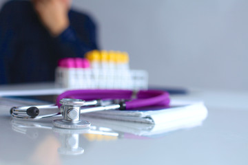 Medical doctor  sitting at table and looking patients roentgen