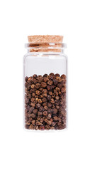 Black pepper in a glass bottle with cork stopper, isolated on wh