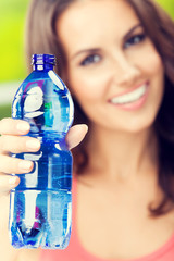 Young woman with bottle of water, outdoor