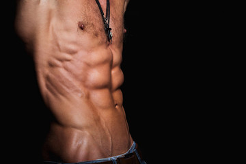 Fototapeta na wymiar Muscular and sexy torso of young sporty man with perfect abs