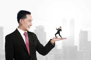 Big boss holding small subordinate