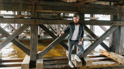 Bearded hipster with nose ring in leather jacket