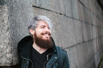 Bearded hipster with nose ring in leather jacket - 86372044