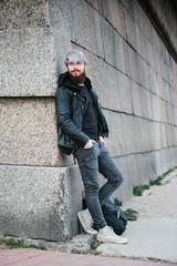 Bearded hipster with nose ring in leather jacket