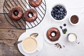 Chocolate donuts with coffee and blueberries