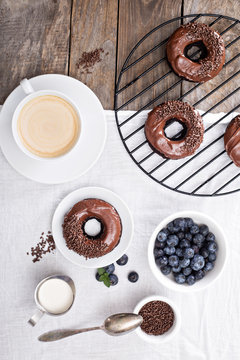 Chocolate donuts with coffee and blueberries