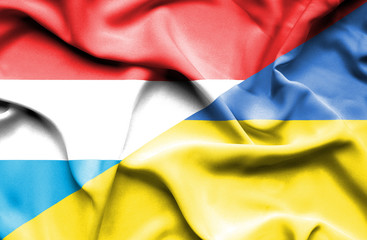 Waving flag of Ukraine and Luxembourg
