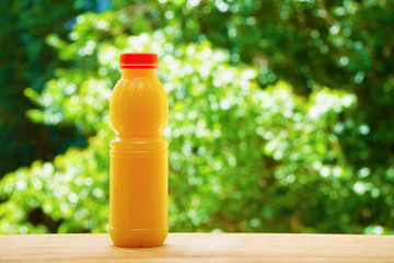 Bottle of orange juice on the wooden table - 86375656