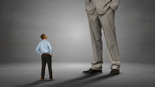 Businessman looking at giant boss 