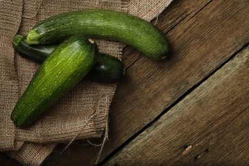 Zucchini on wooden background. Top view.