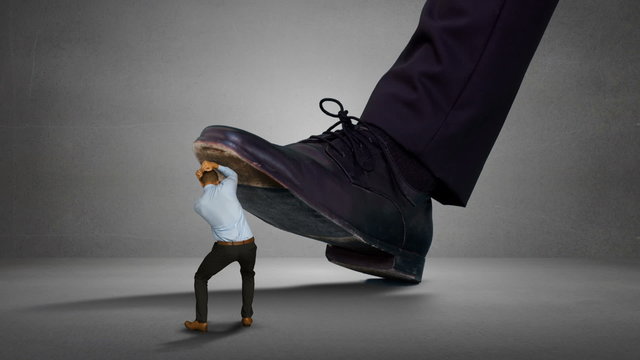 Shoes of giant boss trying to squash his scared employee 