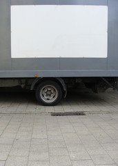 white empty panel on side of a gray truck