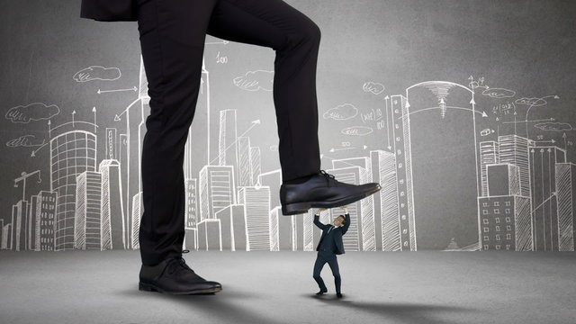 Giant boss trying to squash businesswoman