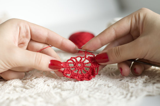 Crocheting a flower pattern in red