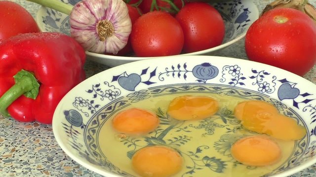 Yellow raw eggs in ceramic bowl
