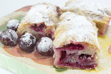 Homemade cherry pie covered with sugar and decorated with raw ch