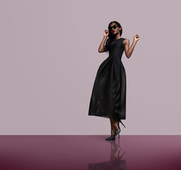 fashion model wearing black dress and sunglasses - 86379898