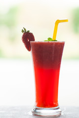 Glass of strawberry smoothie.