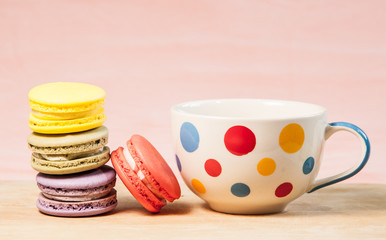 French macarons and cup on table