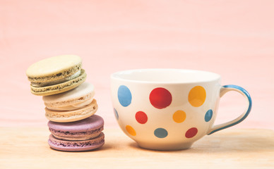 French macarons and cup on table