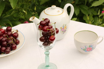 cherry tea cup glass table in a garden courtyard for summer tablecloth selective soft focus