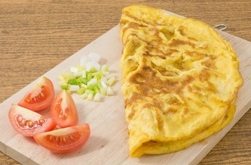 Thai Omelette with Tomatoes and Scallion on Cutting Board