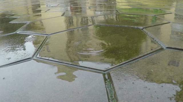 Raindrops Fall to Flagstones in Slow Motion.
