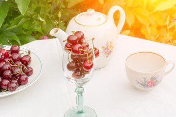 cherry tea cup glass table in a garden courtyard for summer tablecloth selective soft focus