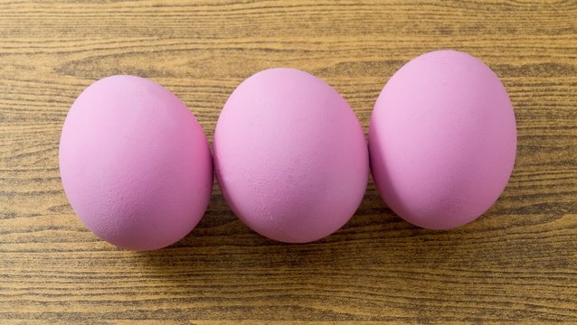 Three Pink Century Egg on Wooden Table