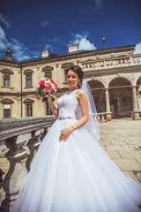 Fototapeta premium Beautiful bride runs between the columns