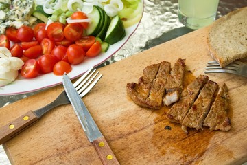 Meat cut on several stripes on chopping board
