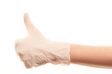 Doctor's hand in white surgical glove showing thumbs up sign