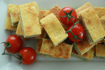 Homemade Ricotta cheese and spinach pie slice with tomato