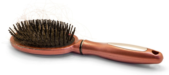 Brown hairbrush with hair loss isolated on white
