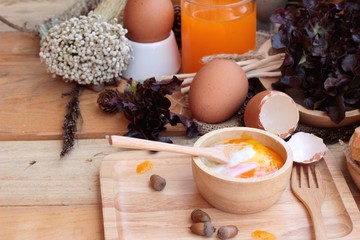 soft-boiled egg and eggs on wood background