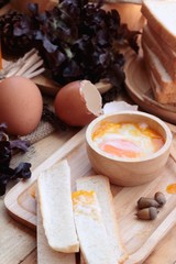 soft-boiled egg with bread on wood background.