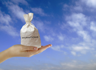 Hand with bag of donations