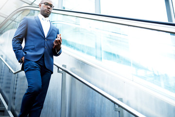 Serious Businessman Using Stairs in Going Down