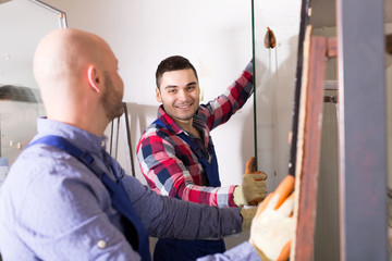 Two smiling workmen at factory