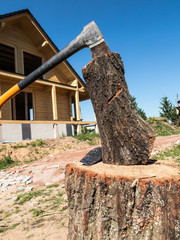 Fototapeta premium ax stuck in a log standing