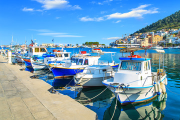 Colorful boats over clear water in peaceful Greek bay, Greece - obrazy, fototapety, plakaty