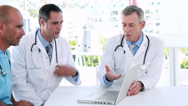 Medical team looking at laptop computer